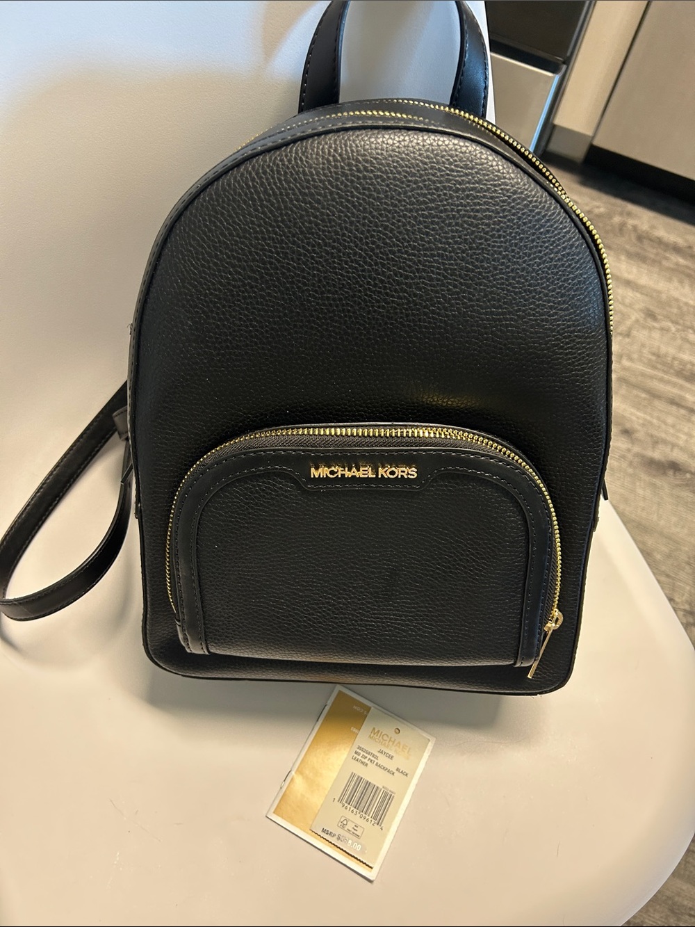 Michael Kors Black Pebbled Leather Mini Backpack with Gold Accents sold out